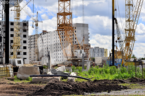 Image of  Construction site with cranes on sky background