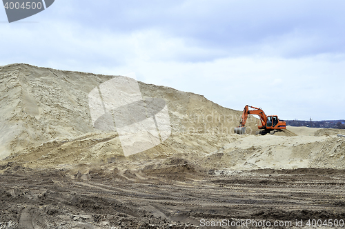 Image of Working digger in a quarry produces sand