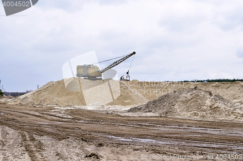 Image of Working digger in a quarry produces sand