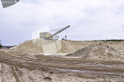 Image of Working digger in a quarry produces sand