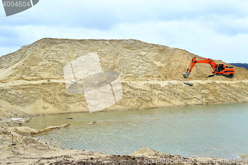 Image of Working digger in a quarry produces sand