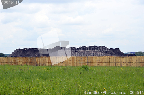 Image of Keeping the soil in the open ground in the warehouse site with a fence