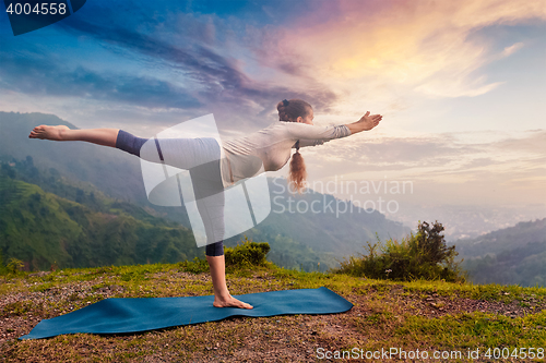 Image of Woman doing Ashtanga Vinyasa Yoga asana Virabhadrasana 3 Warrior