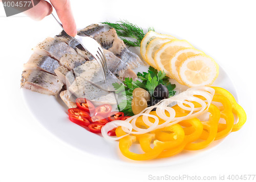 Image of fish on plate with vegetables
