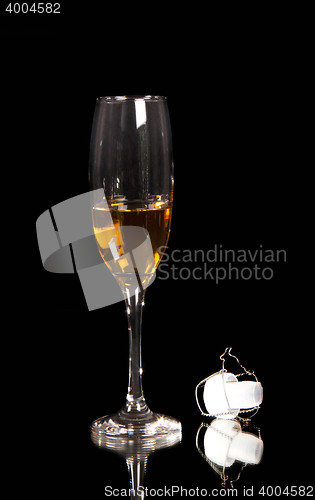 Image of champagne glass with plastic corn