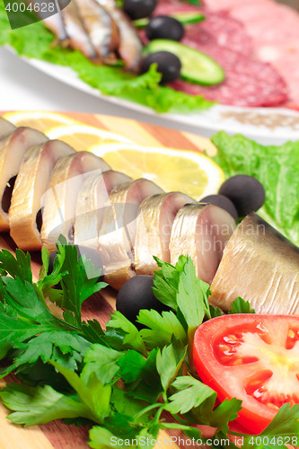 Image of sliced herring with vegetables