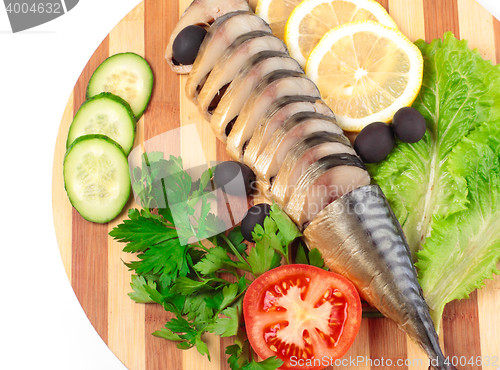 Image of sliced herring on wooden plate