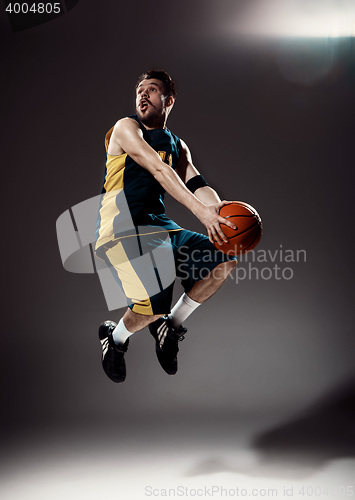 Image of Full length portrait of a basketball player with ball