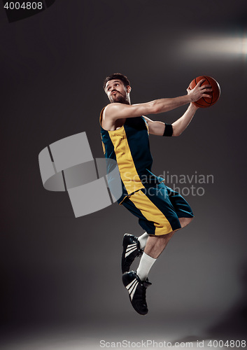 Image of Full length portrait of a basketball player with ball