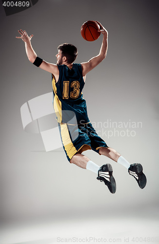 Image of Full length portrait of a basketball player with ball