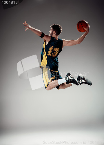 Image of Full length portrait of a basketball player with ball