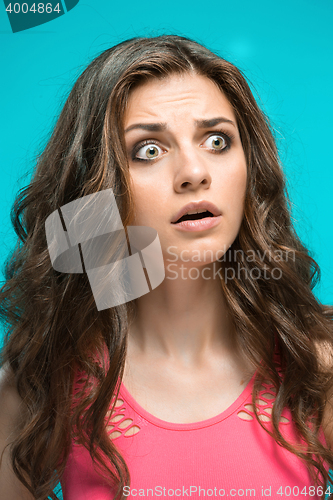 Image of Portrait of young woman with shocked facial expression