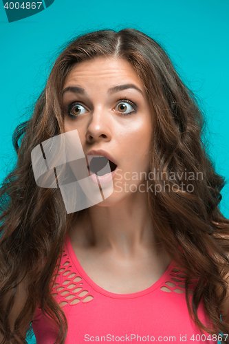 Image of Portrait of young woman with shocked facial expression