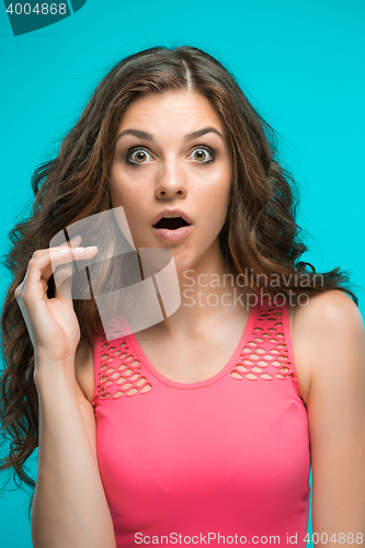 Image of Portrait of young woman with shocked facial expression