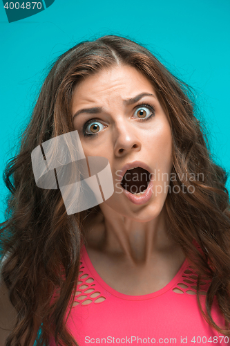 Image of Portrait of young woman with shocked facial expression