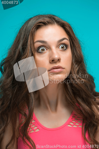 Image of Portrait of young woman with shocked facial expression