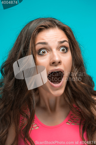 Image of Portrait of young woman with shocked facial expression