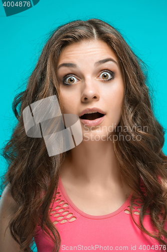 Image of Portrait of young woman with shocked facial expression