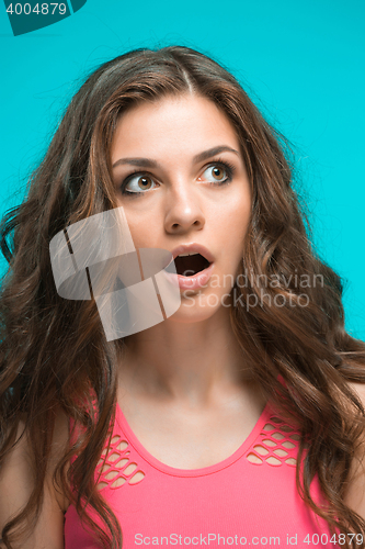 Image of Portrait of young woman with shocked facial expression