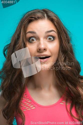 Image of Portrait of young woman with shocked facial expression