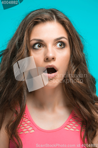 Image of Portrait of young woman with shocked facial expression