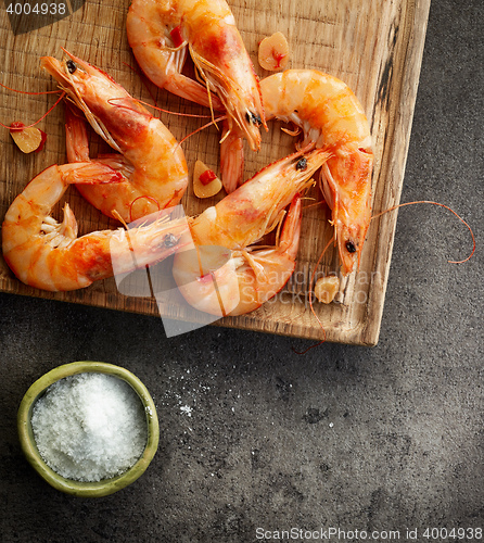 Image of roasted prawns on wooden cutting board