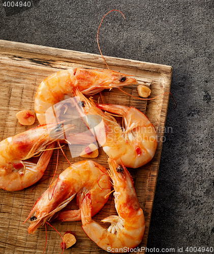 Image of roasted prawns on wooden cutting board