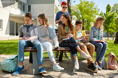 Image of group of students with notebooks at school yard