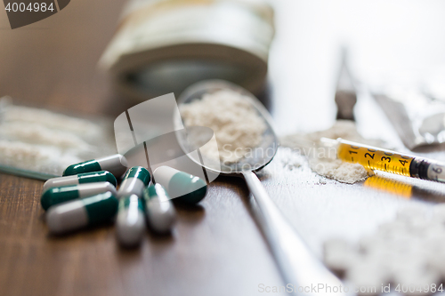 Image of close up of drugs, money, spoon and syringe
