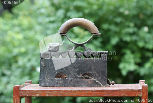 Image of Retro iron on wooden stand