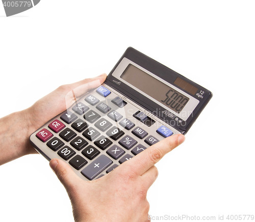 Image of Male businessman using a calculator