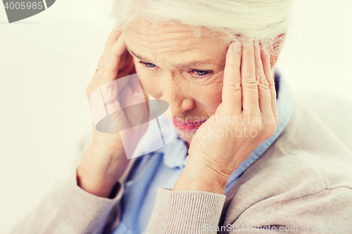 Image of face of senior woman suffering from headache