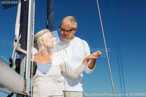 Image of happy senior couple on sail boat or yacht in sea