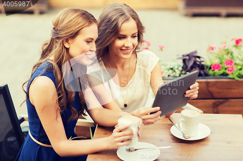 Image of young women with tablet pc and coffee at cafe