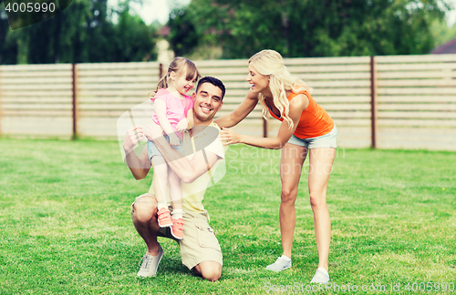 Image of happy family hugging outdoors
