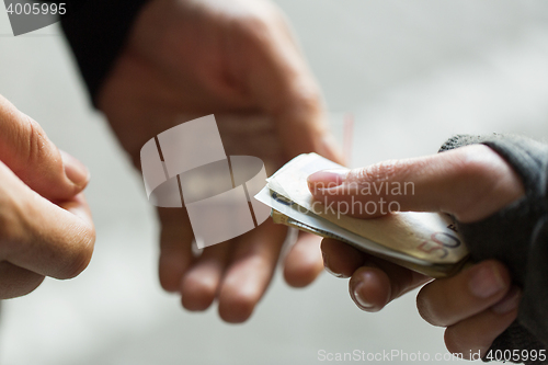 Image of close up of addict buying dose from drug dealer