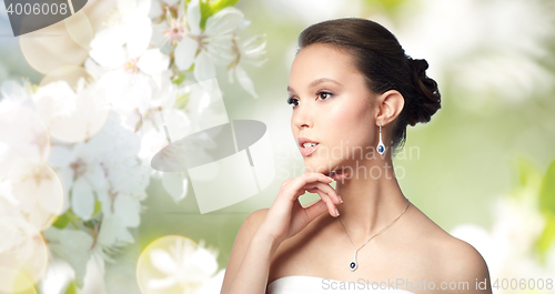 Image of beautiful asian woman with earring and pendant