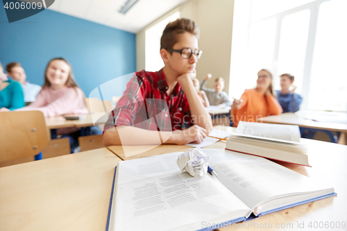 Image of classmates laughing at student boy in high school