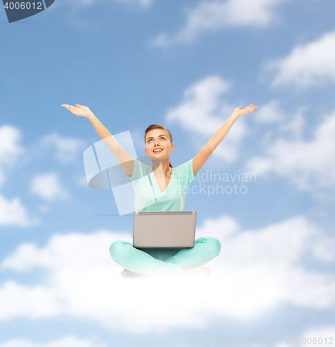 Image of happy young woman with laptop sitting on cloud