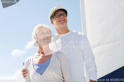 Image of senior couple hugging on sail boat or yacht in sea