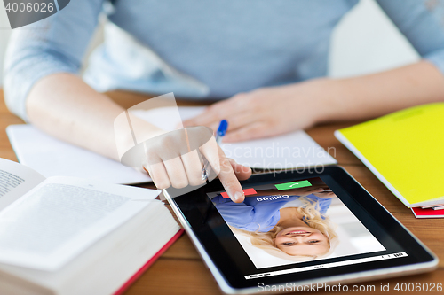 Image of close up of woman with incoming call on tablet pc