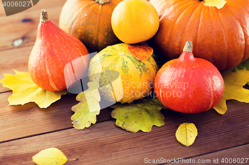 Image of close up of pumpkins on wooden table at home