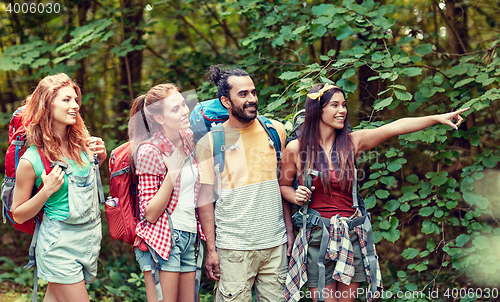 Image of group of smiling friends with backpacks hiking