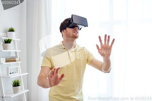 Image of young man in virtual reality headset or 3d glasses