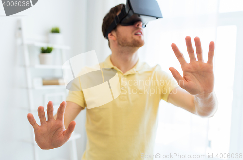 Image of young man in virtual reality headset or 3d glasses
