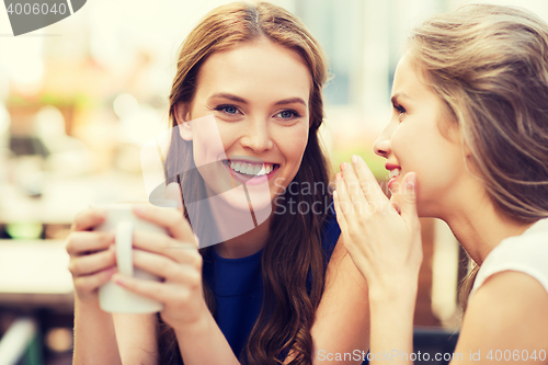 Image of young women drinking coffee and talking at cafe