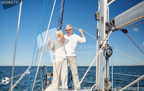 Image of senior couple hugging on sail boat or yacht in sea