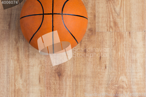 Image of close up of basketball ball on wooden floor