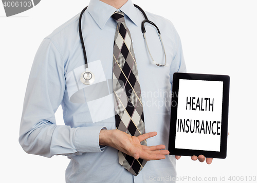 Image of Doctor holding tablet - Health insurance
