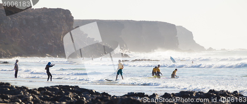 Image of Surfers surfing on El Cotillo beach, Fuerteventura, Canary Islands, Spain.